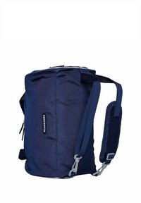 Mochila azul marino con forma cilíndrica, hecha de tela resistente, con correas ajustables y un bolsillo lateral. Cierre de cremallera en la parte superior.