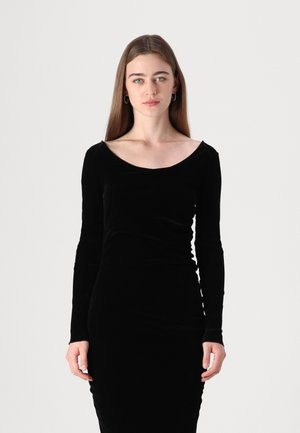 Black velvet dress with long sleeves, scoop neckline, and fitted design. Smooth texture with subtle side ruching details.