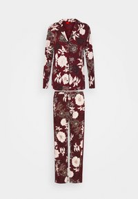 Floral pajama set in burgundy with long-sleeve jacket and matching pants. Features large white and black flowers, soft fabric, and a button-up design.