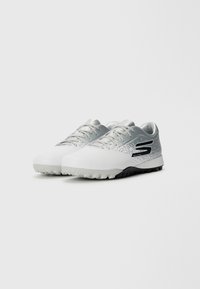 White athletic shoes with a gray and black gradient, featuring a textured upper, laces, and a patterned sole for traction.