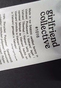 Clothing label from girlfiend collective displaying item number #1016, made in a SABOCO certified factory in Vietnam, with recycled polyester content.
