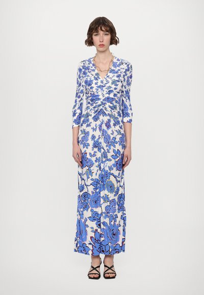 Maxi dress in lightweight fabric with a blue floral pattern on a white background. Features a V-neck, three-quarter sleeves, and gathered design.