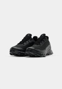 Chaussures de sport noires au design élégant, avec une tige texturée, des lacets noirs et une semelle extérieure robuste pour une meilleure adhérence. Matériau léger utilisé.