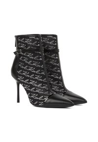 Mustad mustelakot välustega kingad terava varbaga, valmistatud nahast ja võrgu materjalist, kaunistatud mustriga. Lisatud rihm koos riistvaraga.