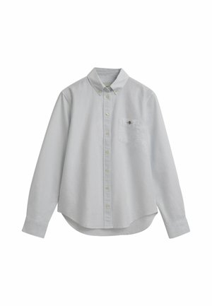 Light blue button-up shirt made of a textured fabric. Features a collar, long sleeves, a chest pocket, and a rounded hem.