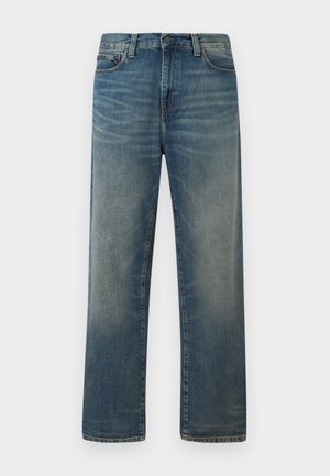 Sinised sirgelõikelised teksapüksid pleekinud pesuga, ees toimib nööpide ja tõmblukuga kinnis, klassikalise viie taskuga disain.