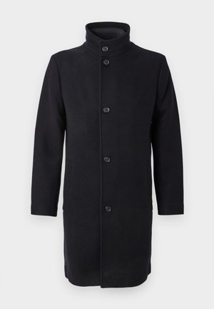 Langer schwarzer Mantel mit hohem Kragen, aus Stoff gefertigt, mit fünf Knöpfen auf der Vorderseite und seitlichen Taschen. Klassischer, gerader Schnitt.
