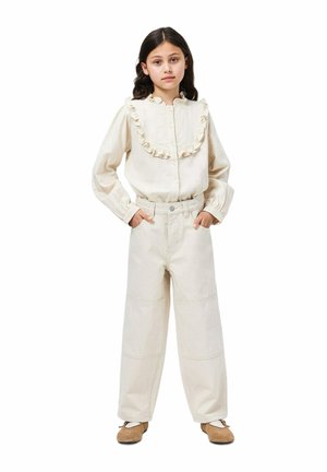 Beige long-sleeve shirt with ruffled collar, button front. Wide-leg beige pants with pockets, soft texture, and matching color.