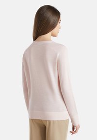 Helles rosa Langarm-Sweatshirt mit Rundhalsausschnitt, gerippten Bündchen und einem leicht verlängerten hinteren Saum. Hergestellt aus einem weichen, glatten Stoff.