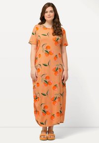 Orange maxi kjole med korte ærmer, prydet med et mønster af orange frugter og grønne blade, lavet af et glat, let stof.