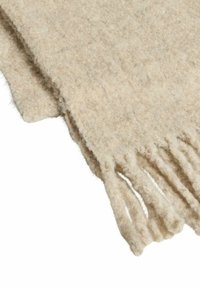 Écharpe en laine beige clair avec une texture douce, dotée d'extrémités frangées et d'un design simple et sans ornement, idéale pour superposer.