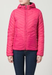 Pink, zippered puffer jacket with a hood, features chevron quilting and a lightweight design. Paired with dark blue jeans.