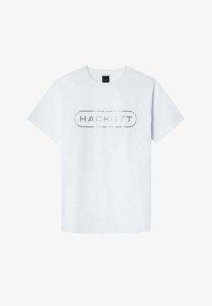 Bijela pamučna majica s kratkim rukavima. Ima srebrni otisak "HACKETT" logotipa u ovalnom obliku na prsima. Jednostavan dizajn, klasičan kroj.