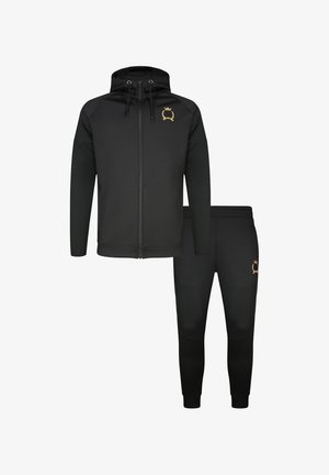 Czarna bluza z kapturem na zamek z troczkami oraz dopasowane spodnie dresowe, oba z małym złotym emblematem korony na lewej piersi i udzie.