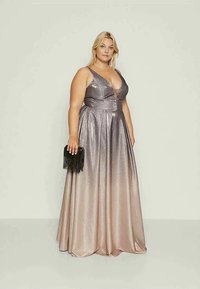 Metallic silver and pink ombre gown with a deep V-neck, fitted bodice, and flowing skirt. Model holds a black fringed clutch.