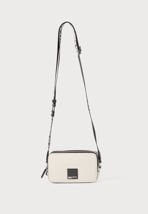Rectangular crossbody bag in light gray material, featuring a black zip, logo plaque, and adjustable strap with a patterned accent.