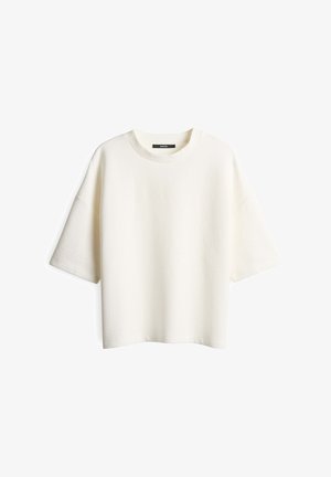 T-shirt bianco corto con maniche a sbuffo e colletto rotondo, caratterizzato da una vestibilità comoda e senza chiusure o fantasie visibili.