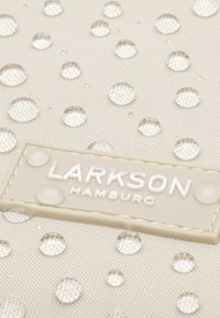 Beige waterproof fabric featuring numerous clear droplets, with a textured appearance. A white rectangular logo patch reads "LARKSON HAMBURG."
