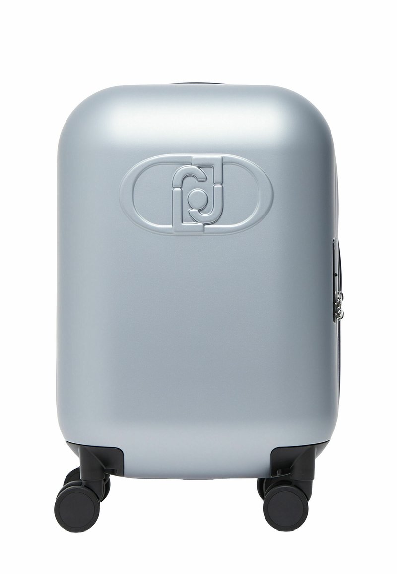 Valise rigide argentée avec quatre roues pivotantes noires et un logo ovale en relief au centre avant.