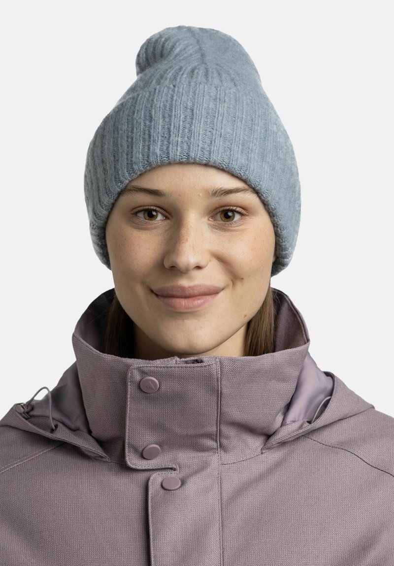 Light blue knitted beanie with a ribbed texture and a tapered top, paired with a purple collared jacket featuring snap buttons.