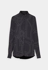 Camicetta nera a manica lunga con bottoni frontali, caratterizzata da motivi di cucitura astratti bianchi e un colletto a punta. Tessuto liscio e vestibilità rilassata.