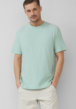 Mintgrünes Kurzarm-T-Shirt mit Rundhalsausschnitt, aus weichem Stoff mit strukturierter Oberfläche. Lässige Passform mit entspannter Silhouette.