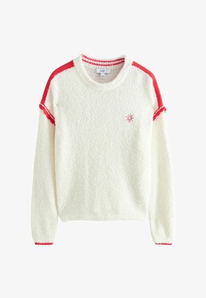 Biały miękki sweter z długimi rękawami, czerwonymi paskami na ramionach i mankietach oraz małym czerwonym emblematem śnieżynki na piersi.