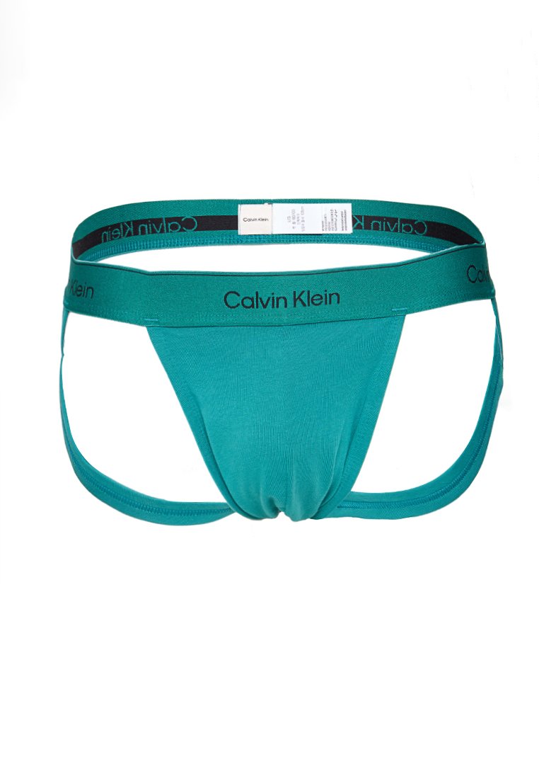 Taurfarbener Calvin Klein Jockstrap für Herren mit schwarzem Logo-Bund und angenähtem Pflegeetikett auf der Rückseite.