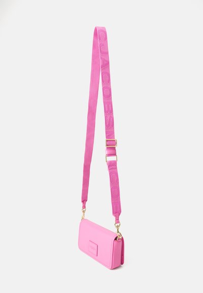 Pink faux leather crossbody bag with a rectangular shape, textured strap featuring embossed branding, and gold-tone metal hardware.