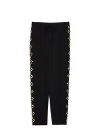 Zwarte drawstring broek met elastische taille, voorzien van gouden en zilveren kralen en pailletten versieringen langs de buitenzij seams.