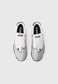 White and silver athletic shoes with a smooth synthetic upper, black accents, and white laces featuring ventilation holes along the sides.