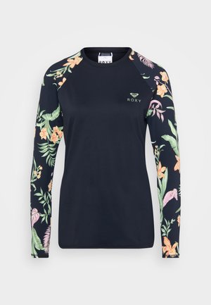 Langsleeve rashguard in marineblauw met bloemenpatroon op de mouwen. Glad, elastisch materiaal met een klein logo in het midden.
