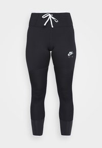 Leggings sportivi neri con vita alta, coulisse bianca, pannelli texturizzati sulle ginocchia e un piccolo logo Nike Air bianco sulla coscia.