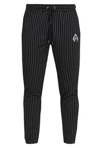 Black striped jogger pants made of soft fabric, featuring an elastic waistband with drawstring and a small logo detail on the side.