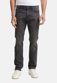 Dark grey denim jeans with a classic fit, featuring front pockets, a button closure, and subtle fading. Worn with white sneakers.