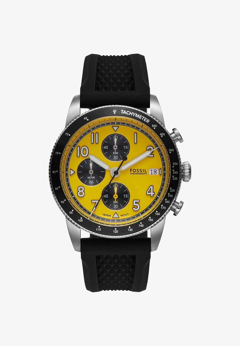 Fossil kronograf ur med gul urskive, sorte subskiver, tachymeter ring, dato display, sølv etui og sort tekstureret gummirem.