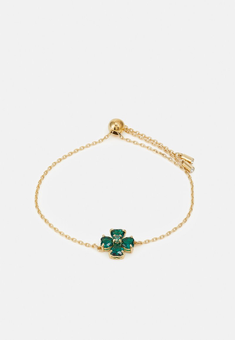 Pulsera de cadena de oro con un diseño de cruz de gema verde en el centro. Longitud ajustable con un cierre redondeado y eslabones delicados.
