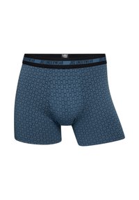 Blå mønstrede boxershorts med diamantdesign, blødt stof og en sort elastisk talje med "JBS UNDERWEAR" skrift.