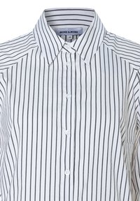 White button-up shirt with vertical black stripes. Features a collar, six buttons, and a soft fabric texture. Tag reads "MORE & MORE."