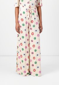 Wide-leg trousers with floral patterns in pink, blue, and green on a cream background; elastic waistband with a drawstring for adjustment.