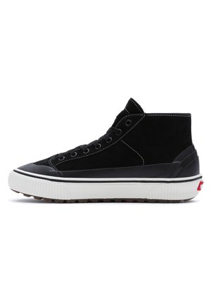 Schwarzer High-Top-Sneaker mit weißer Gummisohle, schwarzen Nähten, Schnürung vorne und strukturierter Zehenkappe, seitlich auf weißem Hintergrund gezeigt.