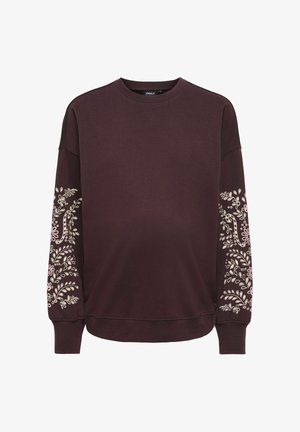 Ciemnobrązowa bluza z okrągłym dekoltem, z prążkowanymi mankietami i wzorami kwiatowych pnączy w jasnoróżowym kolorze na obu rękawach.