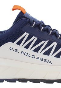 Navy blue athletic shoe with white accents, featuring mesh upper, prominent branding, textured sole, and an orange pull tab.