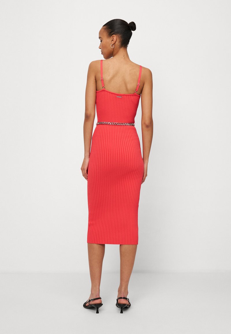 Ripp-midi-Kleid in Koralle, mit verstellbaren Trägern und einem Kettengürtel. Glatte Textur mit figurbetonender Silhouette und knielangem Saum.