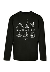 Schwarzes langärmliges T-Shirt mit weißen Skelett-Yoga-Posen und dem Wort "NAMASTE" in fetten Buchstaben auf der Vorderseite. Aus Baumwolle.