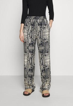 Pantaloni a gamba larga con un motivo a righe nere e crema, dotati di una vita elastica, caratterizzati da una vestibilità morbida e tasche laterali. Tessuto testurizzato.