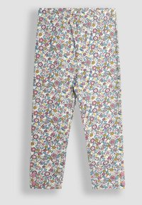 Leggings floreali con sfondo bianco, caratterizzati da un motivo colorato di fiori rosa, gialli e blu. Vita elasticizzata, vestibilità slim.