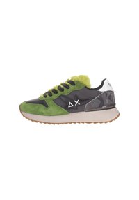 Zapatilla con gamuza verde, cuero negro, talón de camuflaje, forro de piel de lima, cordones negros, suela blanca y símbolos delta y X blancos en el lateral.