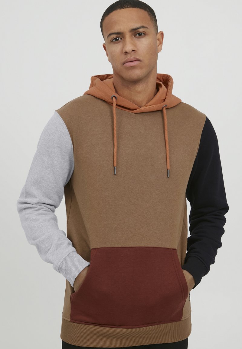 Hooded sweatshirt featuring a blend of brown, grey, and navy panels, with a burgundy pocket and textured fabric. Adjustable drawstrings included.