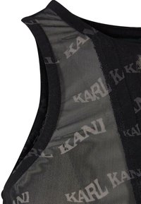 Svart ermeløs topp laget av gjennomsiktig mesh-stoff, med et gjentakende "KANI" tekstmønster og en solid svart kant i halsen.